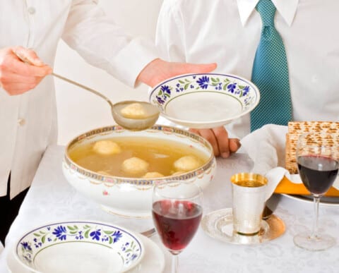 mother serving Kneidel soup at Passover family Seder